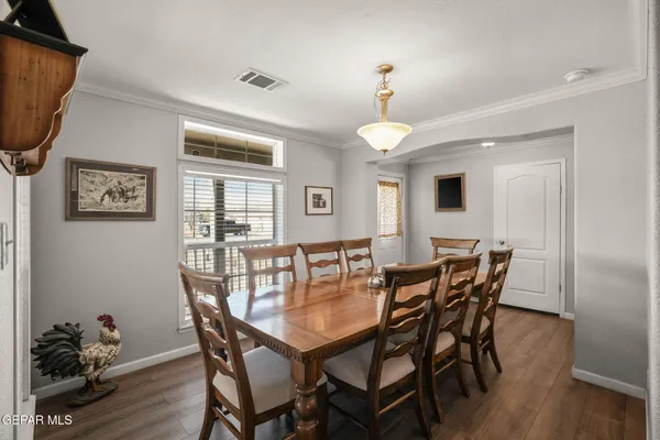 a view of a dining room with furniture and wooden floor