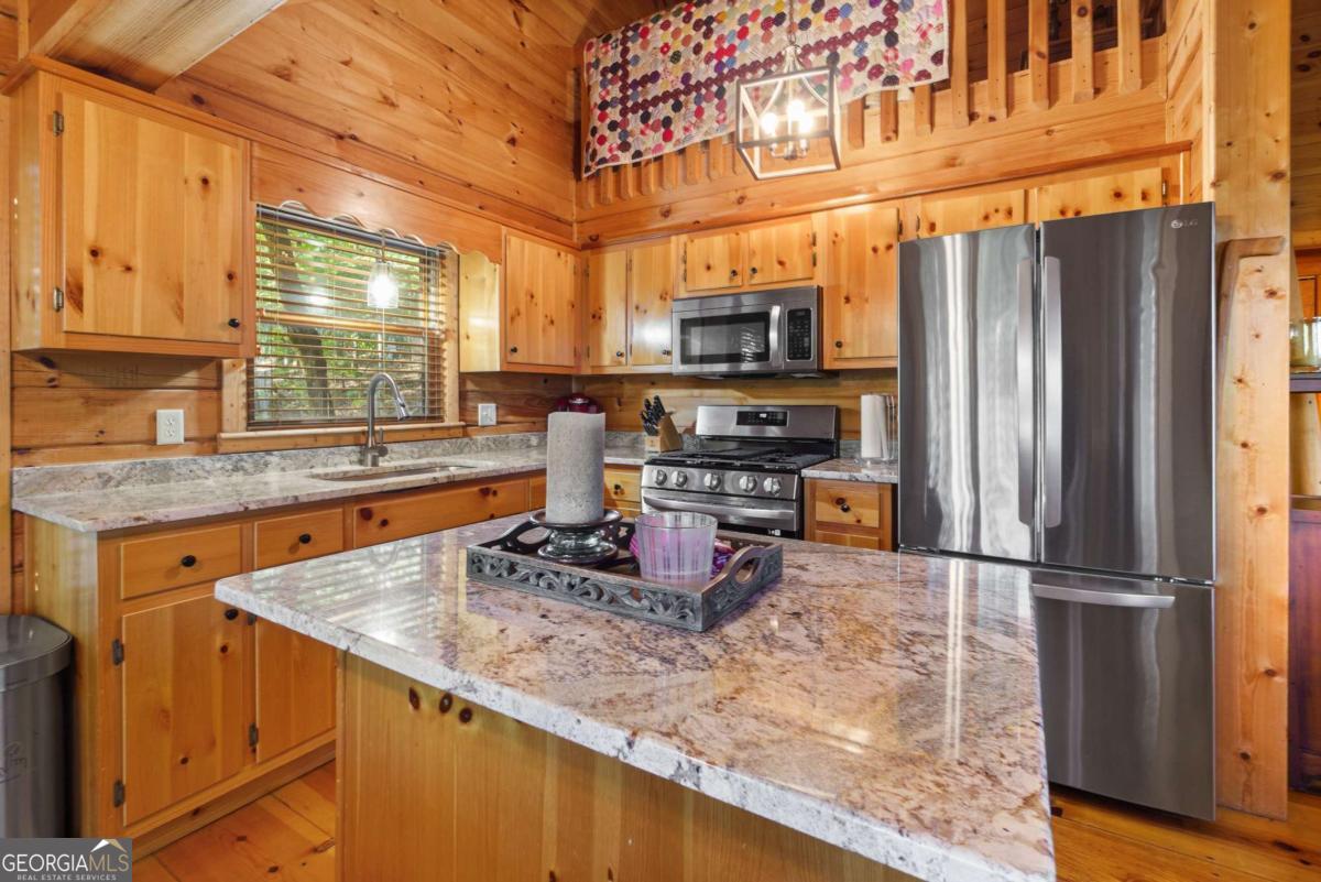 24 Casey Court Blue Ridge, GA 30513 - Photo 14 of 54 a kitchen with stainless steel appliances granite countertop a sink a stove and a refrigerator