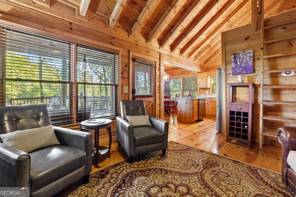 24 Casey Court Blue Ridge, GA 30513 - Photo 17 of 54 a living room with furniture and a floor to ceiling window