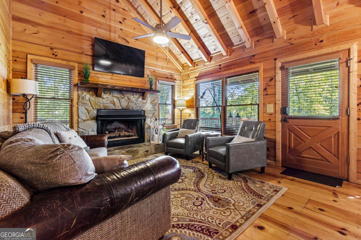 24 Casey Court Blue Ridge, GA 30513 - Photo 19 of 54 a living room with furniture a flat screen tv and a fireplace
