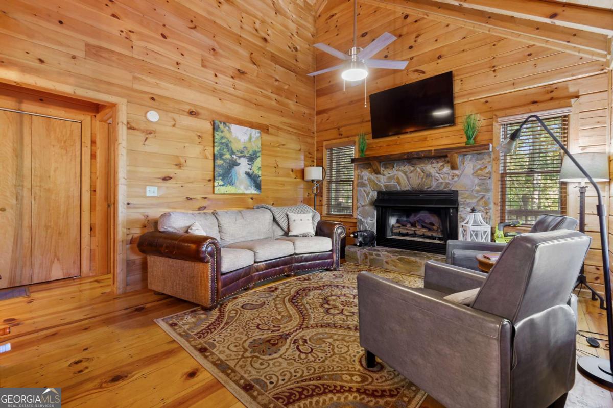24 Casey Court Blue Ridge, GA 30513 - Photo 20 of 54 a living room with furniture a flat screen tv and a fireplace