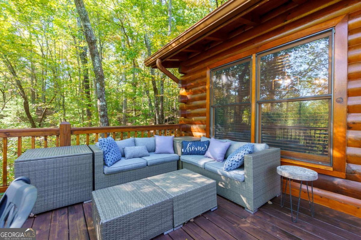 24 Casey Court Blue Ridge, GA 30513 - Photo 25 of 54 a roof deck with couch and wooden floor