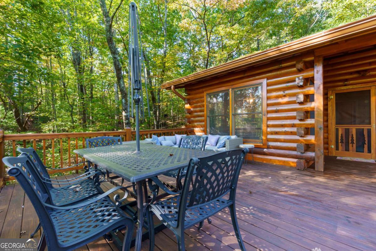 24 Casey Court Blue Ridge, GA 30513 - Photo 26 of 54 a backyard of a house with wooden floor outdoor seating and yard in the back