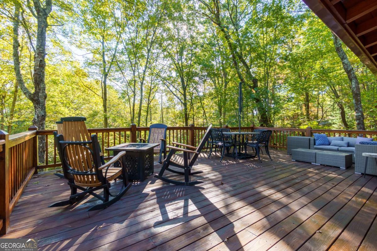 24 Casey Court Blue Ridge, GA 30513 - Photo 30 of 54 a view of a roof deck with table and chairs and wooden floor