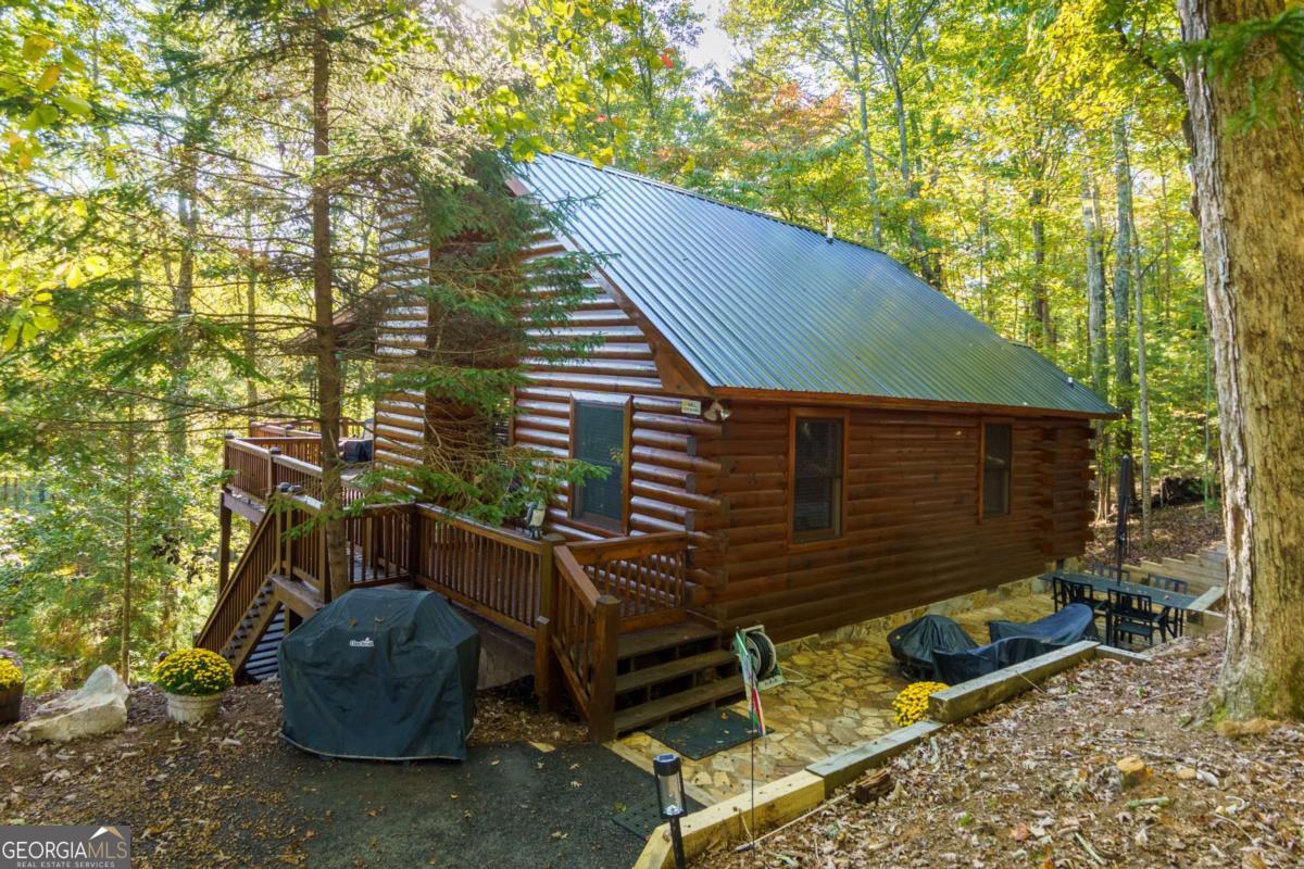 24 Casey Court Blue Ridge, GA 30513 - Photo 49 of 54 a view of a backyard with chairs and a fire pit