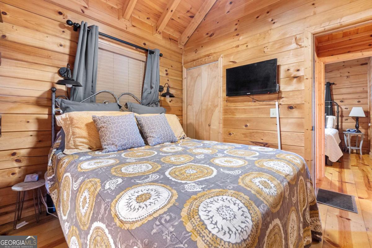 24 Casey Court Blue Ridge, GA 30513 - Photo 6 of 54 a bedroom with a bed and a flat screen tv