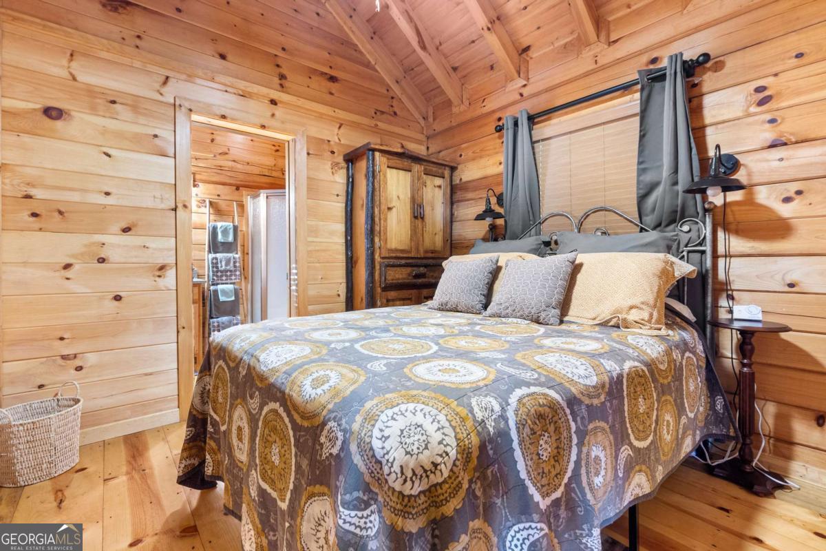 24 Casey Court Blue Ridge, GA 30513 - Photo 7 of 54 a bed sitting in a bedroom next to a window