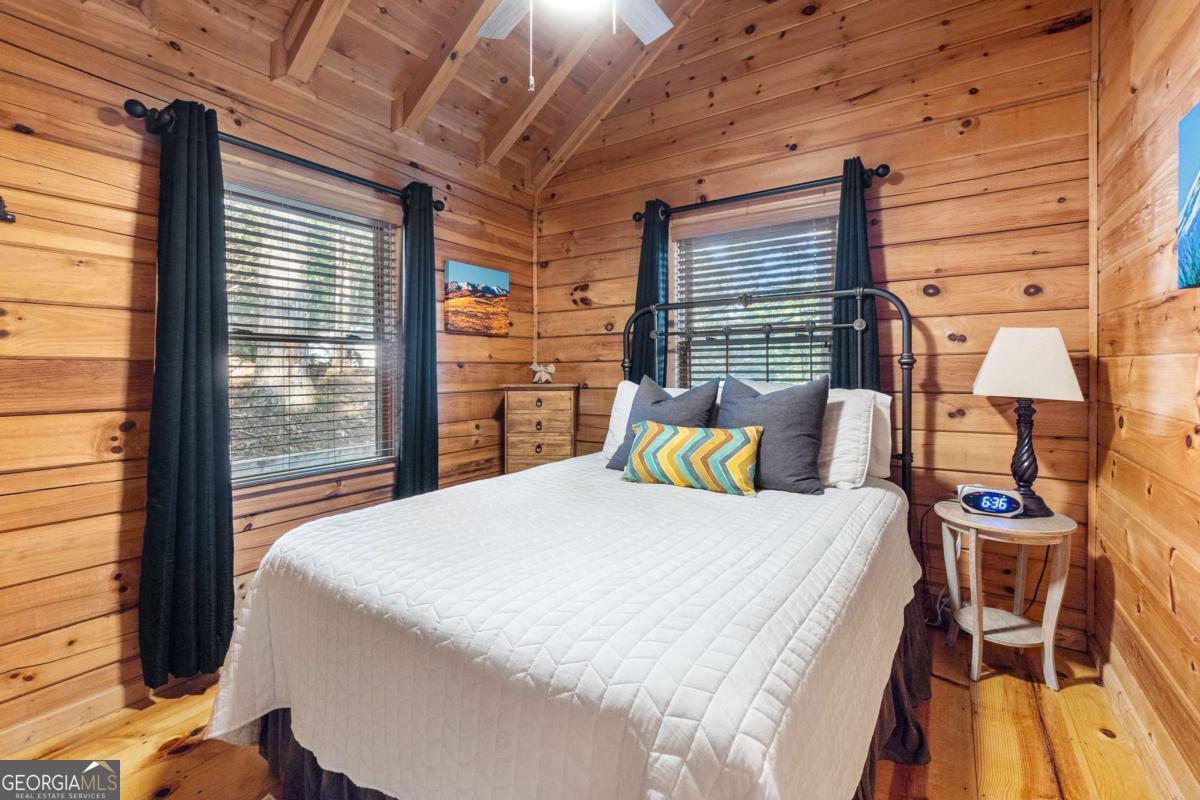 24 Casey Court Blue Ridge, GA 30513 - Photo 10 of 54 a bed sitting in a bedroom next to a window