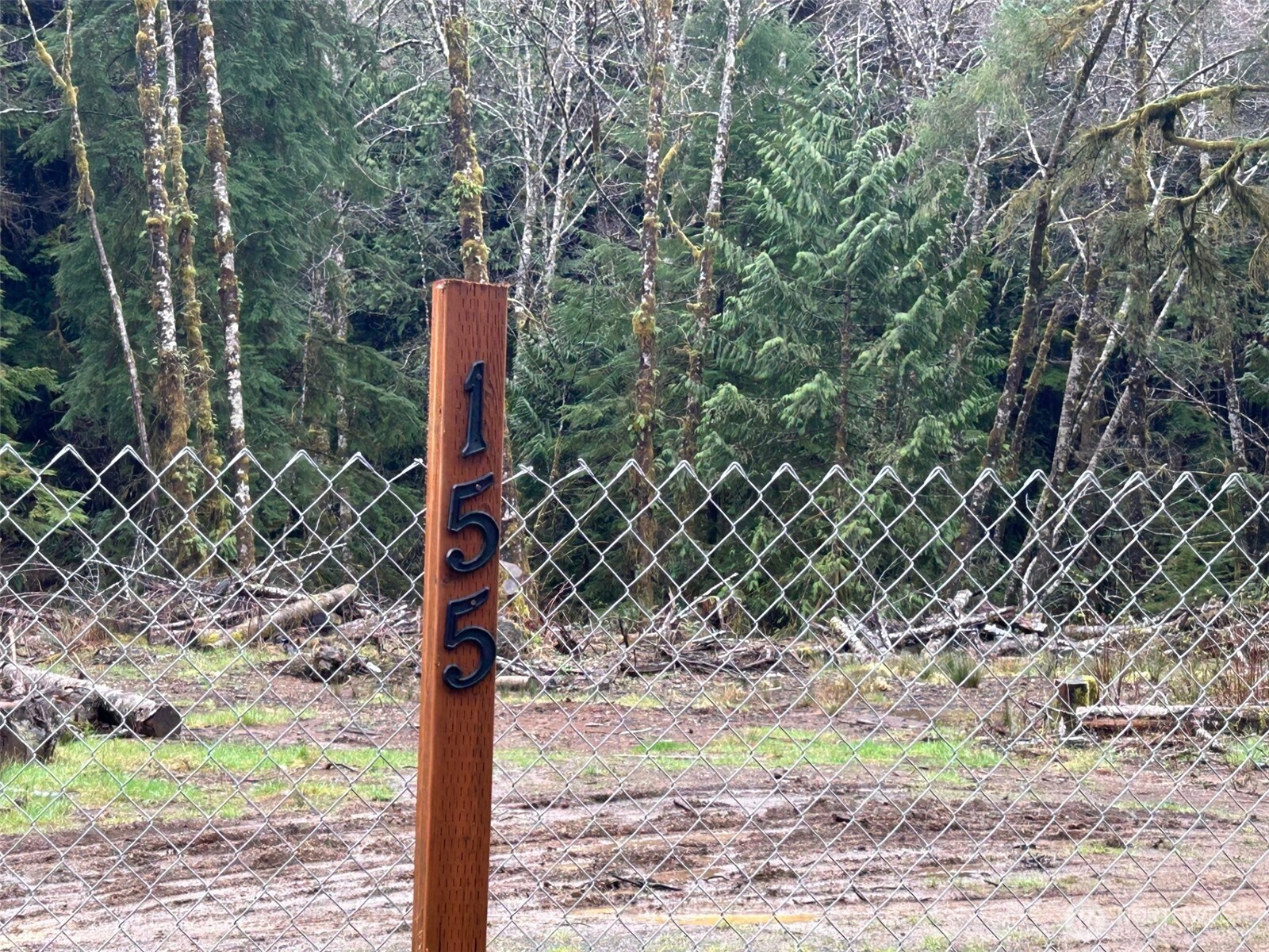 155 Ocean Beach Road Hoquiam, WA 98550 - Photo 15 of 21 a street sign on a sidewalk next to a road