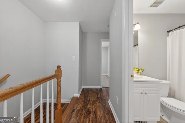 a view of hallway with wooden floor