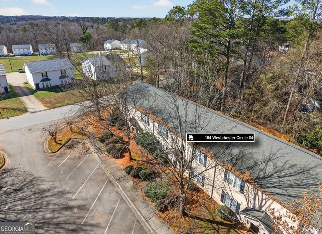 an aerial view of a house with a yard and lake view