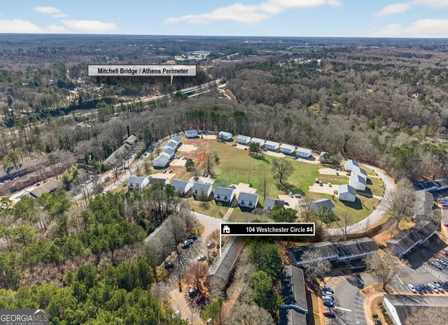 a view of a house with a yard and potted plants