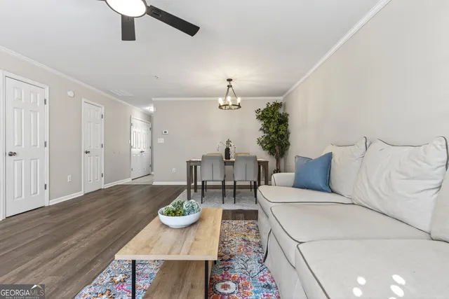 a living room with furniture ceiling fan and a window