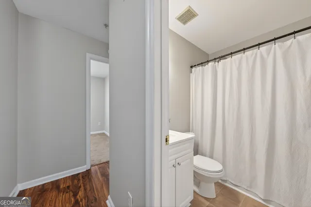 a view of a hallway with a white walls and stairs