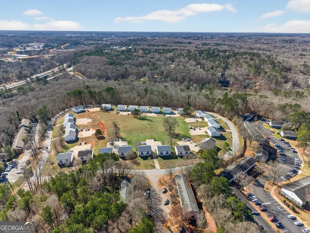 an aerial view of a house with a yard