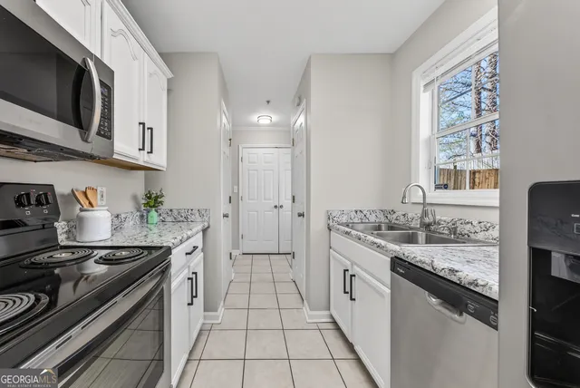 a kitchen with stainless steel appliances granite countertop a stove and a sink