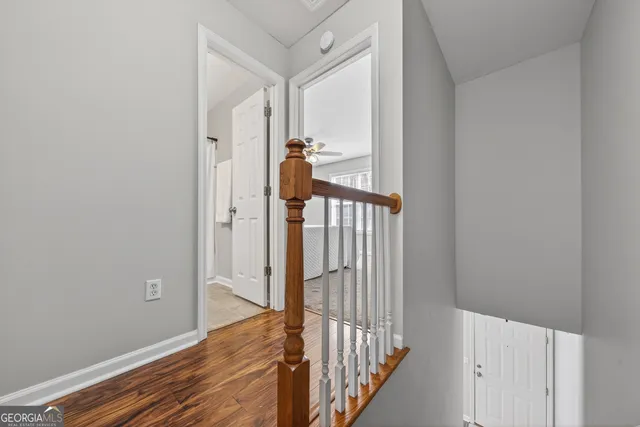a view of a hallway view with wooden floor and staircase