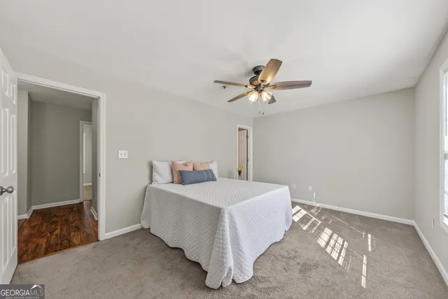 a spacious bedroom with a bed and a chandelier