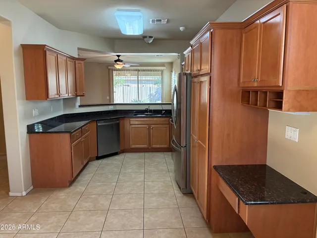 a kitchen with a sink window and cabinets