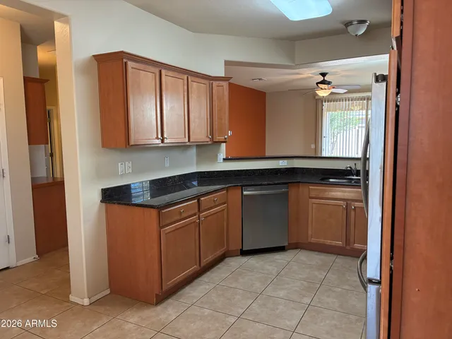 a metallic refrigerator freezer and a stove sitting inside of a kitchen