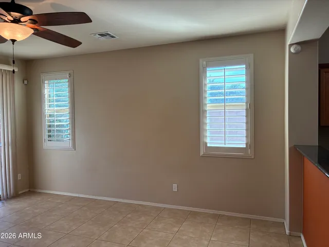 an empty room with windows and cabinet