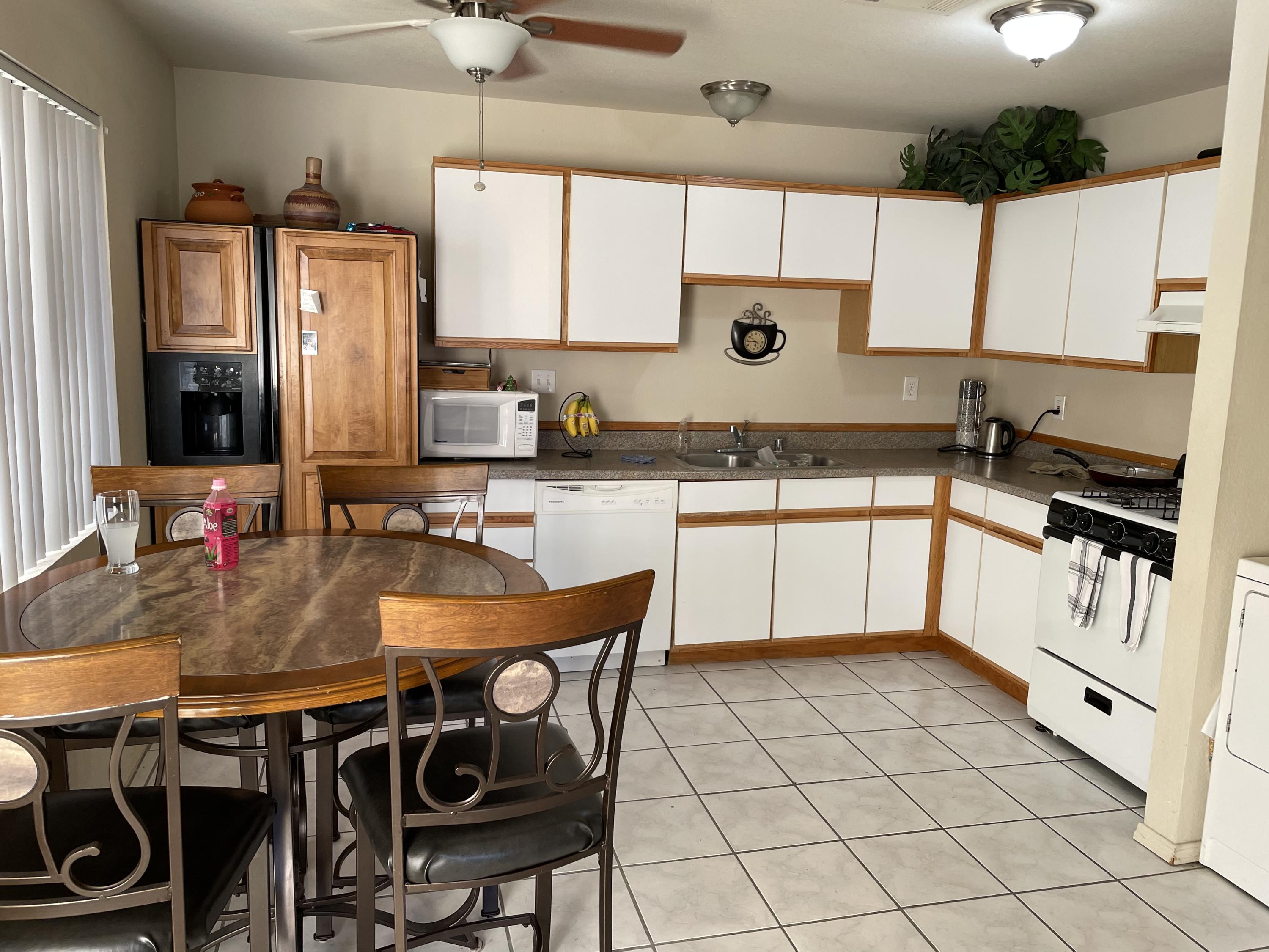 41929 Front Hall Road Bermuda Dunes, CA 92203 - Photo 2 of 12 a kitchen with stainless steel appliances granite countertop a sink a stove a table and chairs
