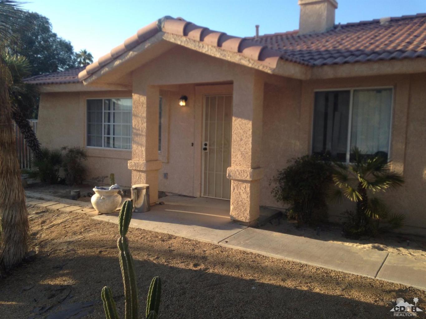 41929 Front Hall Road Bermuda Dunes, CA 92203 - Photo 5 of 12 a front view of a house with a yard