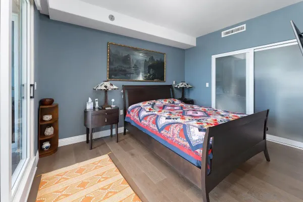 a bedroom with bed and wooden floor