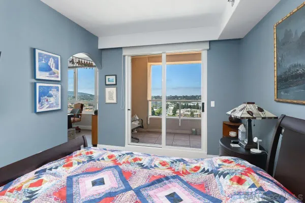 a view of a balcony with chair and a floor to ceiling window