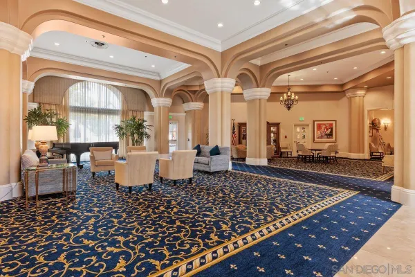 a large room with lots of white furniture