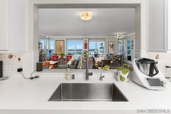 a kitchen with kitchen island stainless steel appliances a sink a counter top cabinets and stove