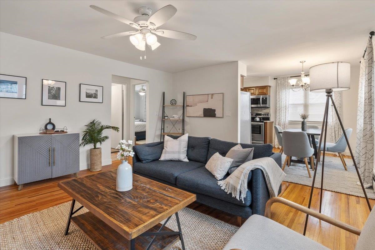 a living room with furniture a flat screen tv and a table
