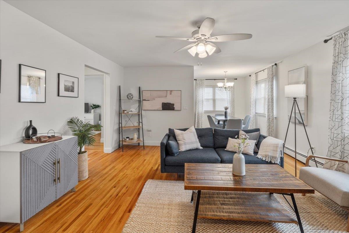 1138F Farm Road, Unit B Secaucus, NJ 07094 - Photo 3 of 20 a living room with furniture and a chandelier