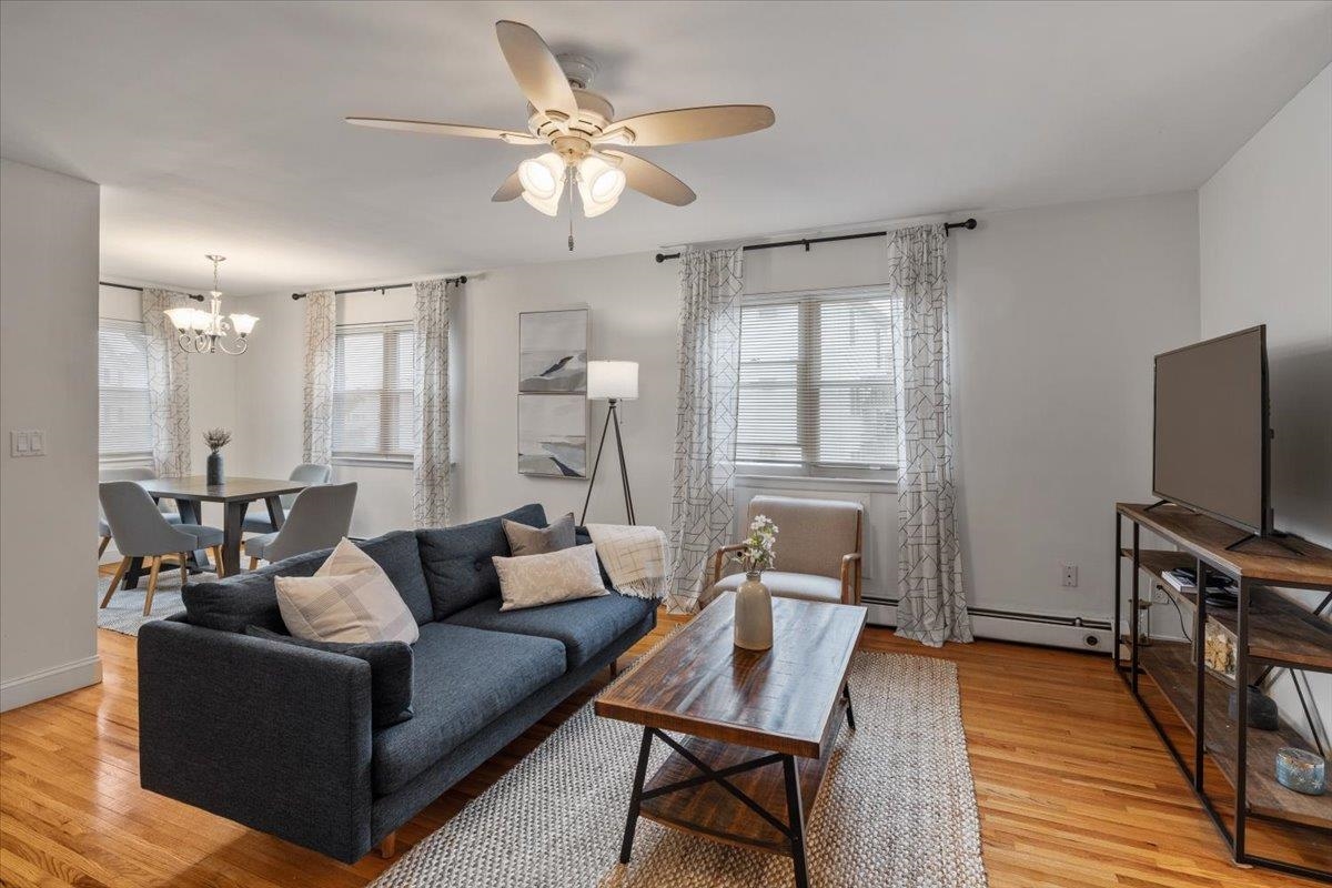 1138F Farm Road, Unit B Secaucus, NJ 07094 - Photo 6 of 20 a living room with furniture a ceiling fan and a flat screen tv