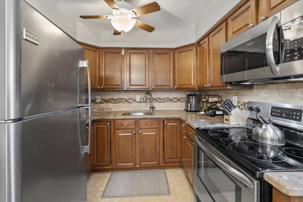 1138F Farm Road, Unit B Secaucus, NJ 07094 - Photo 8 of 20 a kitchen with stainless steel appliances granite countertop a refrigerator a stove top oven a sink and dishwasher
