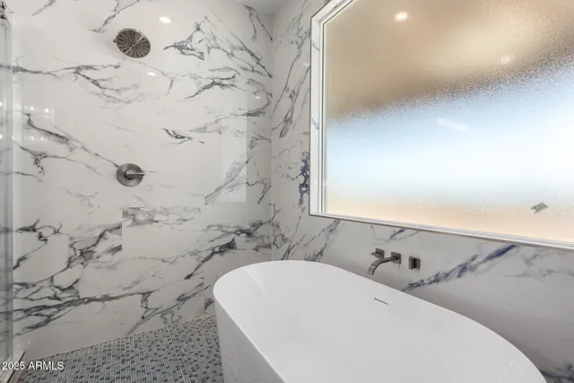 a bathroom with a bathtub and shower