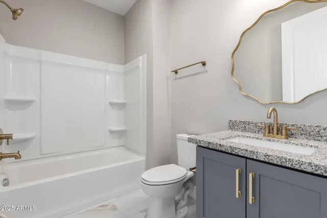 a bathroom with a granite countertop toilet sink and bathtub