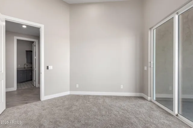 an empty room with closet and a bathroom