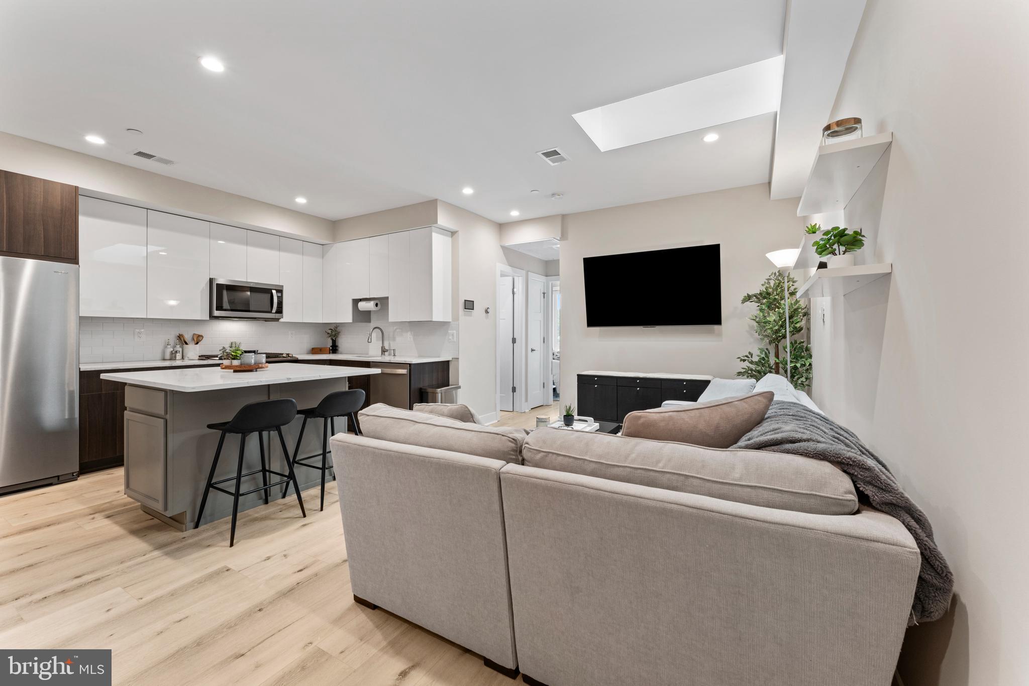 818 Kennedy Street Northwest, Unit 9 Washington, DC 20011 - Photo 23 of 23 a living room with furniture and a flat screen tv