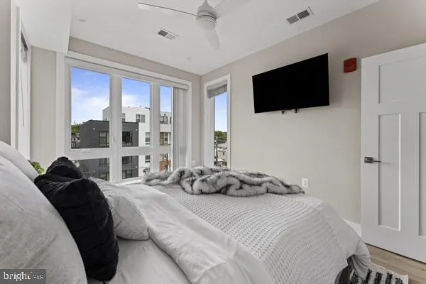 a bedroom with bed and a large window