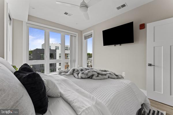 818 Kennedy Street Northwest, Unit 9 Washington, DC 20011 - Photo 11 of 23 a bedroom with a bed a tv and a large window