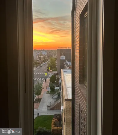 a bedroom with a bed a tv and a large window