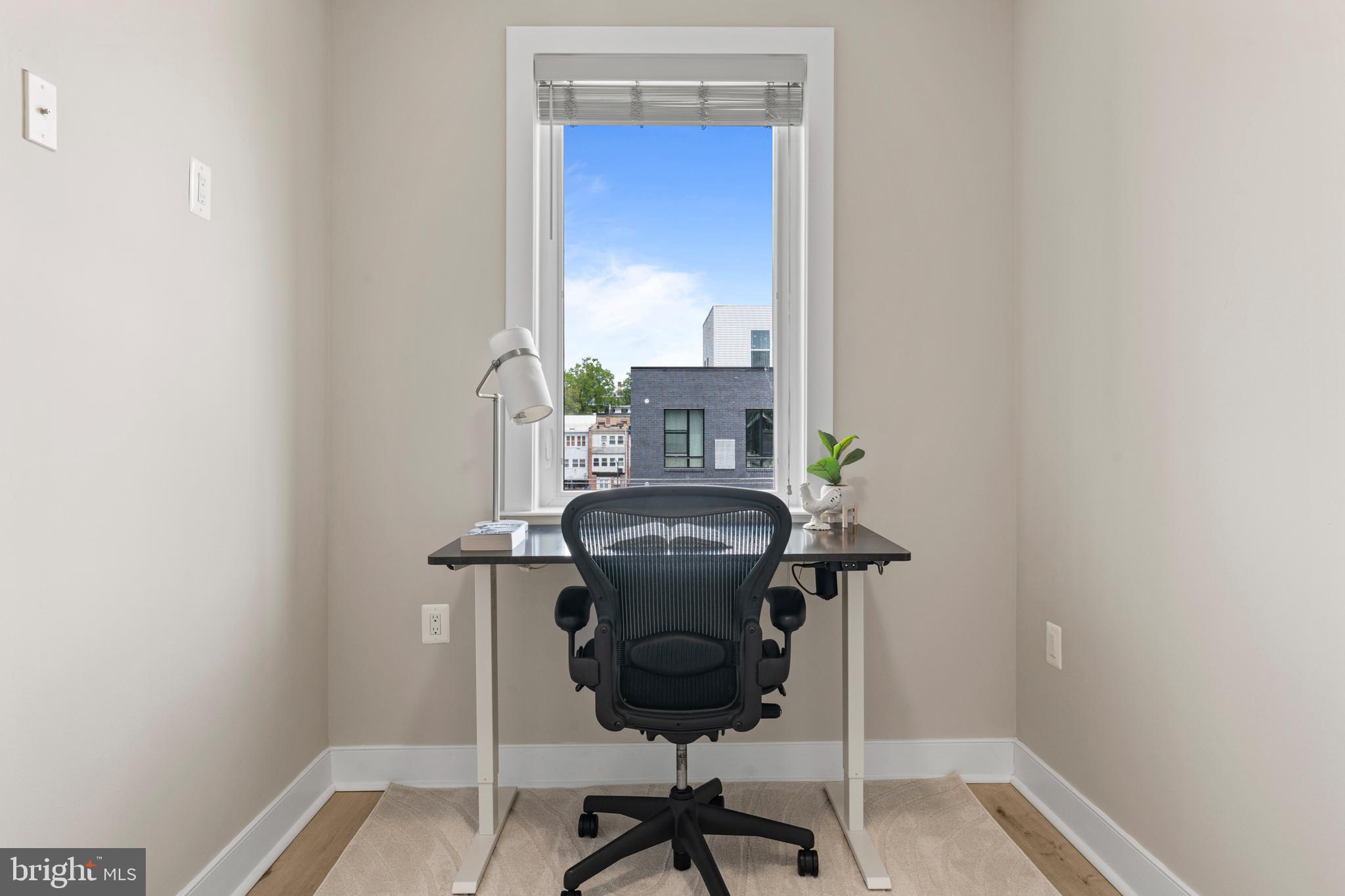 818 Kennedy Street Northwest, Unit 9 Washington, DC 20011 - Photo 14 of 23 a view of a room with a door and wooden floor