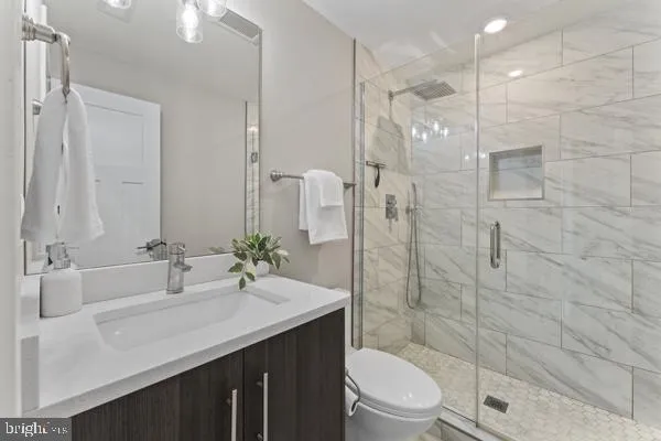 a bathroom with a sink shower and a toilet