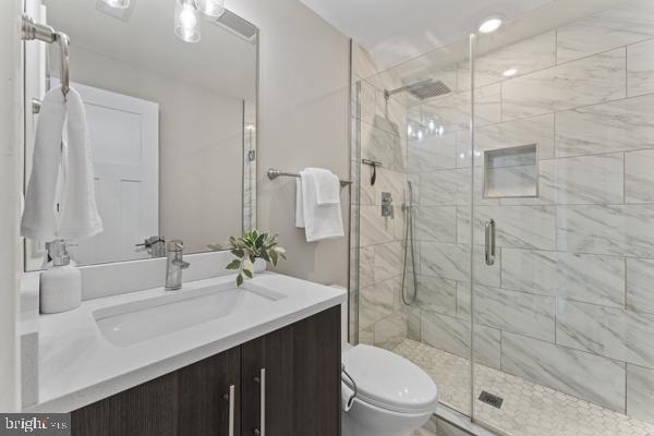 818 Kennedy Street Northwest, Unit 9 Washington, DC 20011 - Photo 16 of 23 a bathroom with a sink shower and a toilet