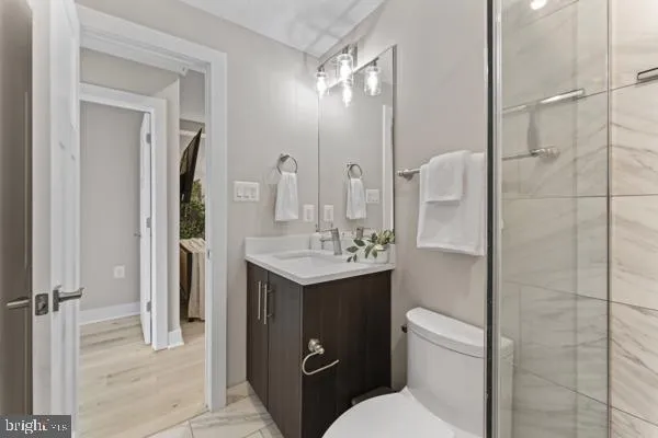 a bathroom with a toilet sink shower and mirror