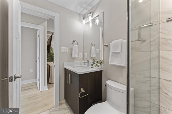 818 Kennedy Street Northwest, Unit 9 Washington, DC 20011 - Photo 17 of 23 a bathroom with a toilet sink shower and mirror