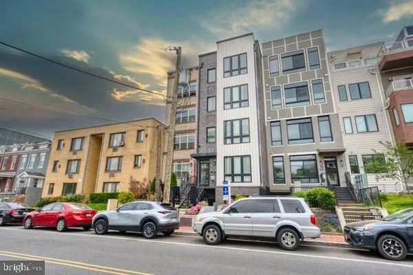 a buildings with car parked in front of it
