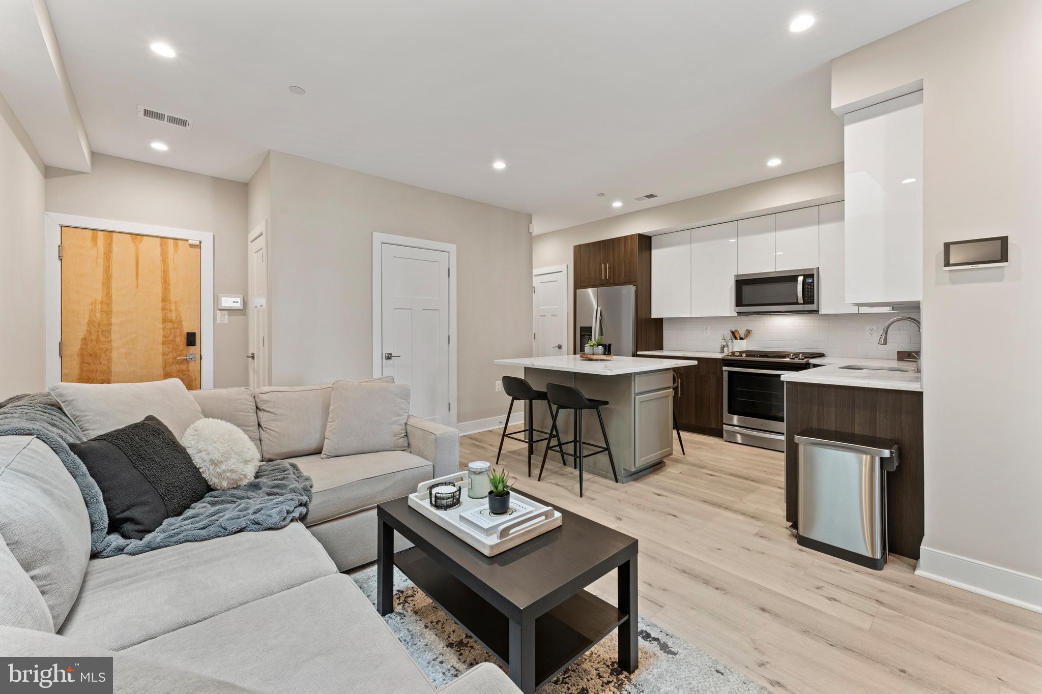 818 Kennedy Street Northwest, Unit 9 Washington, DC 20011 - Photo 2 of 23 a living room with furniture and a wooden floor