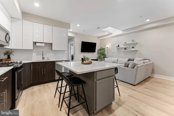 a kitchen with a sink stainless steel appliances and white cabinets